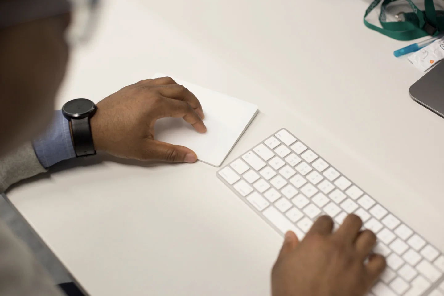 Hands using a keyboard and trackpad at a workstation